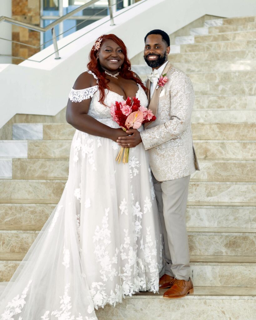 Beautiful couple on stairs of majestic elegance costa mujeres wedding venue