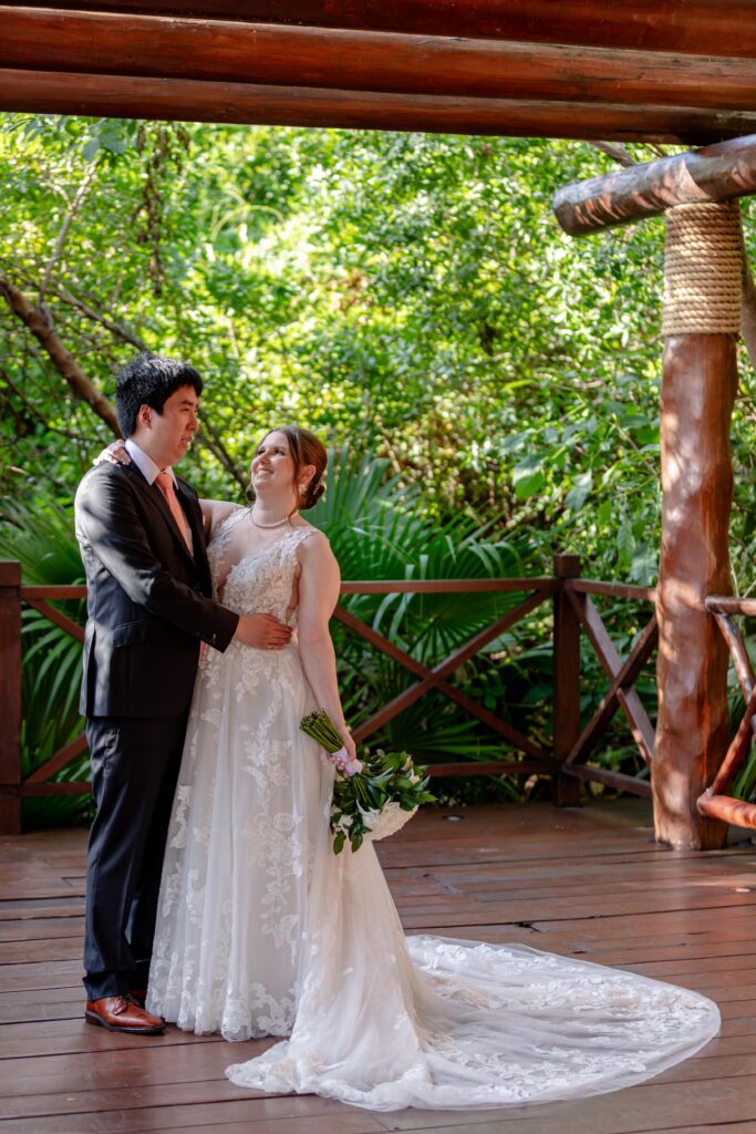 bride and groom in green wedding venue at paradisus playa del carmen